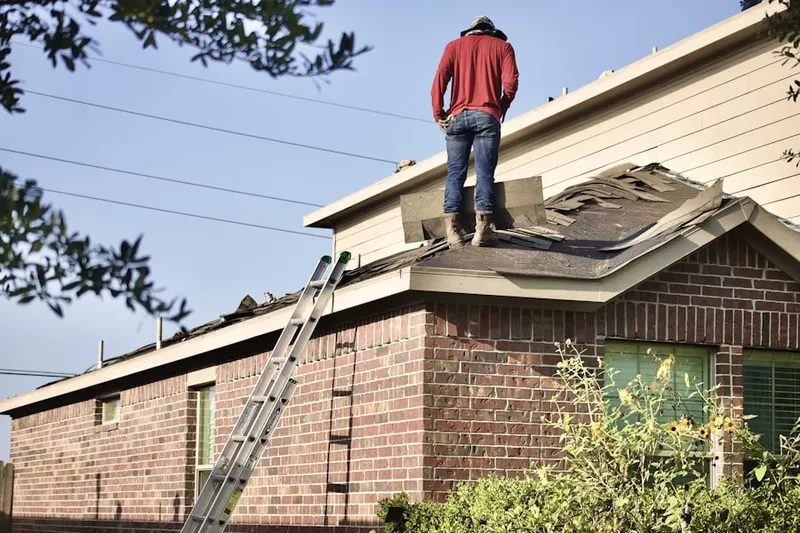 Professional roofer working on a residential roof in Chimney Trace